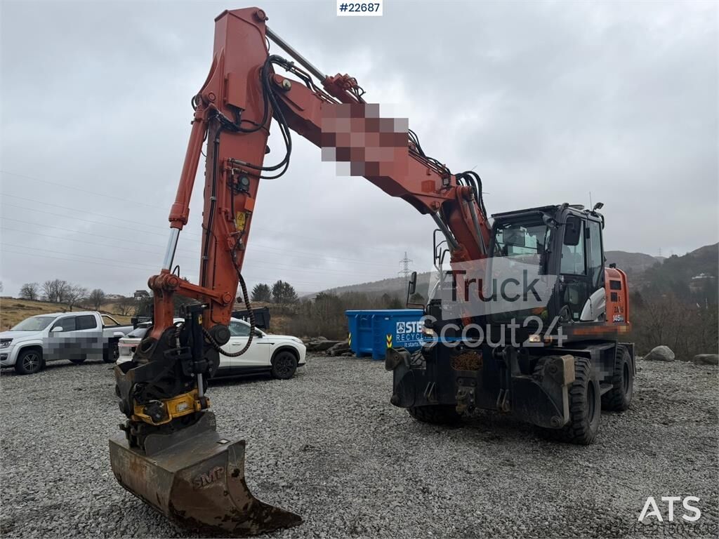 ⇒ Hitachi zx145W wheeled machine w/ rototilt w/grab box, san