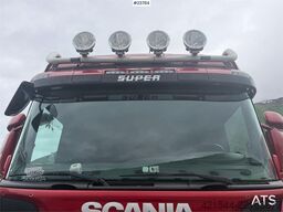Scania R560 plow-rigged dump truck.