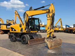 Caterpillar M313D VA - Outriggers + Blade