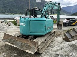 Kobelco Sk140SRLC-3 excavator equipped with a tooth bucket