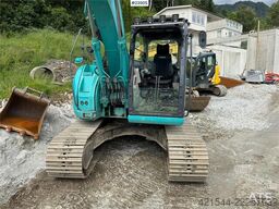 Kobelco Sk140SRLC-3 excavator equipped with a tooth bucket