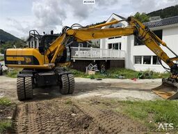 JCB JS145W wheeled machine with a cleaning bucket and
