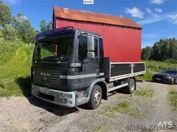 MAN TGL 8.240 4x2 flatbed truck w/ two sets of tires.